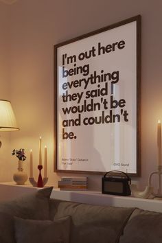 a living room with a large poster on the wall and candles in front of it