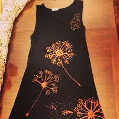 a black dress with orange dandelions on it