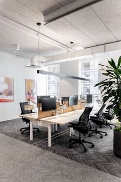 an empty office with desks and chairs