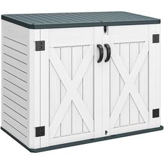 a white storage box with black handles and doors