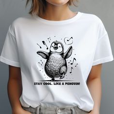 "Embrace the whimsical spirit of penguins and channel their remarkable ability to stay cool under pressure with our \"Stay Cool Like Penguin\" Tee. This shirt is more than just clothing; it's a lighthearted reminder that life's challenges are best met with a touch of humor and a laid-back attitude. Spread positivity and a dash of humor to your friends and loved ones. This tee makes an excellent gift for those who appreciate the value of a carefree approach to life's ups and downs. 🎨👕 Kindly refer to the color charts to verify availability for the size and type of t-shirt you desire. Not every color is offered for each type, although the drop-down menu displays all colors. Please ensure to check the charts; otherwise, the closest available item will be sent to you. 🏷️ We utilize three di Christmas Penguin Shirts, Penguin Graphic, Kimberly Johnson, Penguin Shirt, Happy Penguin, Penguin T Shirt, Types Of T Shirts, Shirt Stays, Animal Shirts