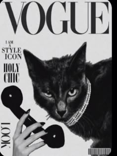 a black and white photo of a woman's hand with a cat on the cover of a magazine