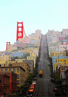 a city street with cars parked on both sides and the golden gate bridge in the background