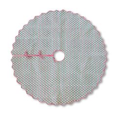 a round doily with pink and green dots on the edge, sitting in front of a white background