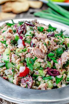 a salad with meat and vegetables in a metal bowl