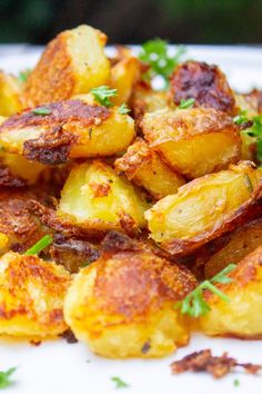 cooked potatoes with parsley on a white plate