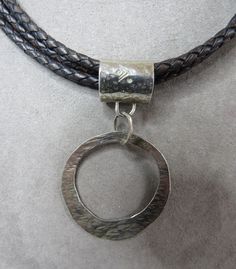 "Here's a sterling silver pendant made and signed by SILPADA, featuring a hammered surface and asymmetrical design. It is item number N1499 and hangs from a triple braided leather cord with sterling end caps and lobster claw clasp. Leather cord measures 17\" and pendant is 2\". The pendant is signed, '925' on the bale, along with the SILPADA logo mark, and leather cord has the Silpada logo hang tag. It is in excellent, clean and wearable condition. Thanks for looking." Round Leather Silver Jewelry, Silver Leather Jewelry, Hammered Pendant, Emerald Ring Gold, Mesh Bracelet, Logo Mark, Asymmetrical Design, Braided Leather, Emerald Ring