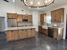 a large kitchen with wooden cabinets and stainless steel appliances