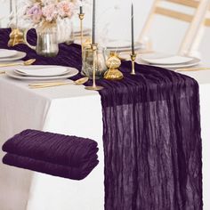 the table is set with purple linens and gold place settings