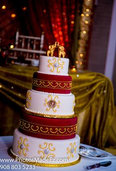 a three tiered wedding cake sitting on top of a table