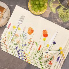 the placemats are decorated with colorful flowers and plants, along with silverware