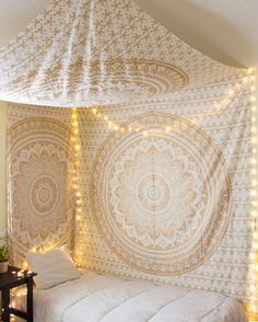 a white bed sitting under a canopy in a bedroom next to a wall with lights on it