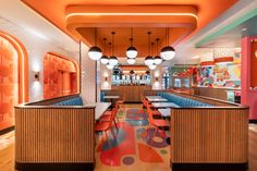 the inside of a restaurant with brightly colored booths