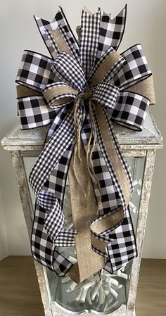 a black and white checkered bow on an old lantern