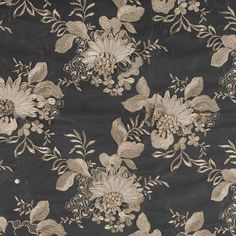 a black background with gold flowers and leaves on the bottom right corner is an embroidered fabric that has been stitched together