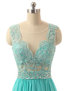 a dress on a mannequin with lace and beaded detailing, in turquoise