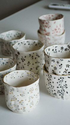 several white and black cups sitting on top of a table