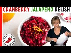 a woman holding a bowl filled with cranberry jalapeno relish