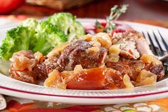 a close up of a plate of food with broccoli and meat on it