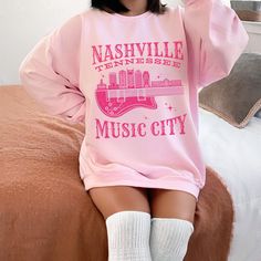 Get ready to be OBSESSED with your new 'Nashville Tennessee Music City' crewneck sweatshirt. It's the cutest and most trendy way to emit all those important Music City vibes! This is the perfect pullover for boho cowgirls, country music festivals, or country concert goers and makes a great gift for Western fashion lovers! Please note, we have intentionally added a distressed effect to this graphic, for a more vintage feel. Have a look around my shop to see what else you'll love! https://www.etsy Pink Long Sleeve Hip Hop Sweatshirt, Pink Hip Hop Sweatshirt For Fall, Pink Crew Hoodie For Fall, Pink Crew Neck Hoodie For Fall, Fall Concert Hoodie Sweatshirt, Pink Hip Hop Sweatshirt With Letter Print, Pink Hip Hop Sweatshirt For Spring, Cotton Hoodie For Fall Concerts, Pink Band Merch Sweatshirt For Streetwear