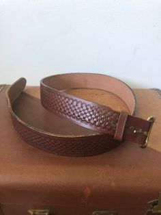 "This tooled Justin belt features fun tooling and a removable buckle. It measures 43 1/4\" long and is 1  6/8\" wide. It is in very good condition. It is clean and ready to use!" Brown Hand Tooled Adjustable Belts And Suspenders, Vintage Belts And Suspenders For Everyday Use, Western Brown Belt Buckles For Everyday Use, Vintage Hand Tooled Leather Belt Buckles, Vintage Belts And Suspenders With Removable Belt, Vintage Distressed Brown Belt For Everyday Use, Retro Leather Belt Buckles, Vintage Leather Belt With Belt Clip, Retro Adjustable Leather Belt Buckles