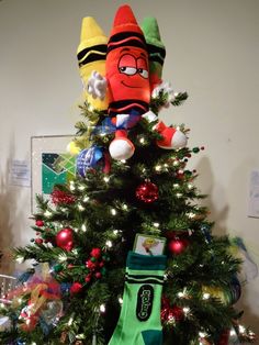 a christmas tree decorated with toys and decorations in the shape of an elf's head