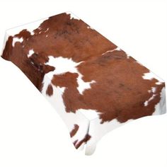 a brown and white cow print table cloth