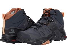 a pair of black and brown hiking shoes