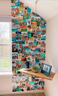 a wall with many pictures on it and a shelf in front of the window,