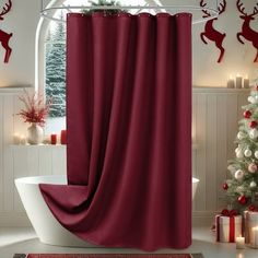 a bathroom decorated for christmas with red shower curtains