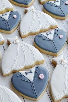 decorated cookies are arranged in the shape of wedding gowns and tuxedo suits