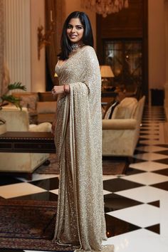 Isha Ambani wears a sequinned gold cocktail Sabyasachi sari at Armaan Jain's sangeet | VOGUE India Isha Ambani, डिजाइनर कपड़े, Sarees For Girls, Indian Sari Dress, Anamika Khanna, Modern Saree, Fancy Sarees Party Wear, Anita Dongre