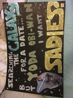 a star wars poster is on the bed with gold glitters and black lettering that reads,'star wars i want to be in the galaxy '