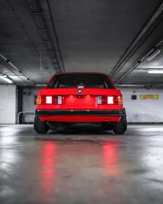 a red car parked in a parking garage