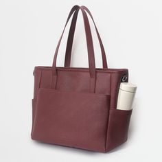 This structured leather tote is the perfect work bag, travel bag, and go anywhere bag. It features a spacious and organized interior for your essentials, a padded compartment for a 15 inch laptop (and 16 inch Macbook Pro), side pockets for your drinks, and you can convert it into a backpack or crossbody. Modern Laptop Bag With Large Capacity For Travel, Large Capacity Tote Briefcase, Large Capacity Laptop Tote Bag For Travel, Versatile Large Capacity Briefcase For On-the-go, Large Capacity Travel Laptop Tote Bag, Functional Large Capacity Tote Briefcase, Daily Use Laptop Bag With Luggage Sleeve, Daily Use Diaper Bag With Luggage Sleeve, Modern Diaper Bag For Travel