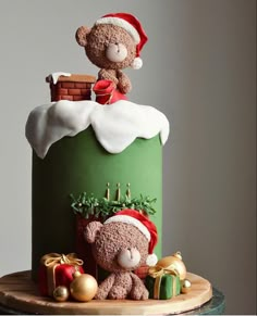 a christmas themed cake with a teddy bear on top