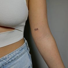 a woman's arm with three small numbers on it