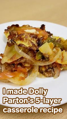 a white plate topped with food on top of a wooden table