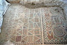 an old floor with designs on it