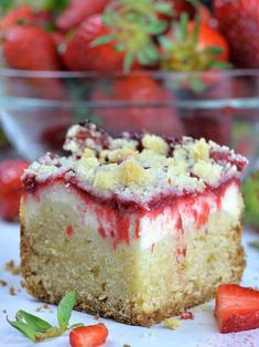 a piece of cheesecake with strawberries in the background