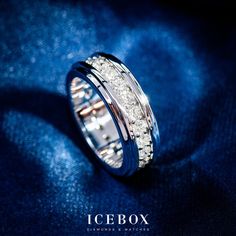 an icebox wedding band is shown on a blue cloth