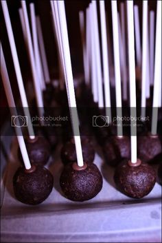 chocolate candies with white sticks sticking out of them