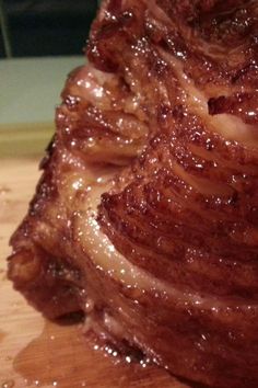 a piece of meat sitting on top of a wooden cutting board