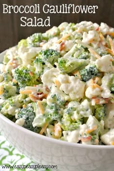 broccoli cauliflower salad in a white bowl on a green and white tablecloth