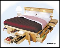 a bed with drawers underneath it and a night stand on the bottom shelf next to it