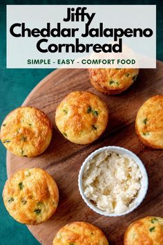 a wooden plate topped with muffins next to a small bowl of cottage cheese