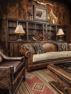 a living room with couches, lamps and rugs on the floor in front of a wooden paneled wall