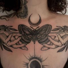 a woman's chest with tattoos on it and an image of a butterfly in the middle