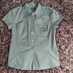 Super Cute Army Green Short Sleeved Sexy Fitted Button Up Blouse Cotton With Epaulettes Patches And Three Pockets Nwt Saze Large Pit To Pit 20 Inches Length 25.5 Inches Khaki Tops With Snap Buttons For Work, Khaki Snap Button Tops For Work, Collared Khaki Top With Snap Buttons, Khaki Collared Top With Snap Buttons, Fitted Khaki Tops With Buttons, Khaki Fitted Button-up Top, Fitted Khaki Button-up Shirt, Summer Button-up Tops With Functional Buttons, Khaki Button-up Top With Snap Buttons