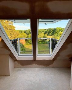 an empty room with two skylights in it